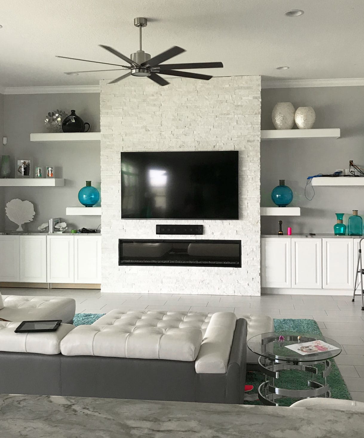 White Stacked Stone on a fireplace in a modern living room was a very popular trend in the summer of 2019
